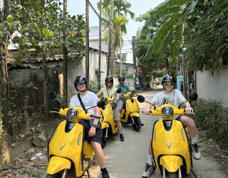 Gezin zoeft door de rijstvelden op elektrische scooters