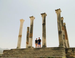 Kinderen bij Romeinse artefacten in Volubilis Marokko